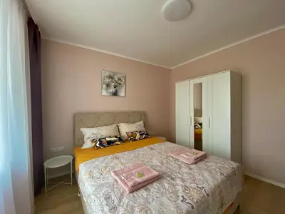 a bedroom with a bed with two towels on it at AVRORA in Varna City