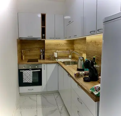 a kitchen with white cabinets and a sink at AVRORA in Varna City