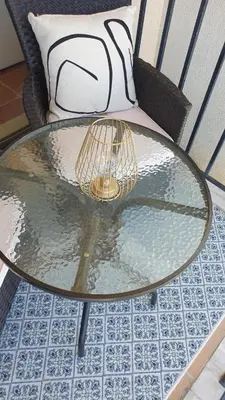 a glass table with a bird cage on a chair at Sea Star Sozopol in Sozopol
