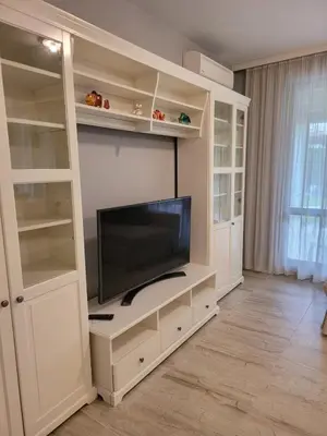 a large white entertainment center with a flat screen tv at Green Line Villa Sozopol in Sozopol