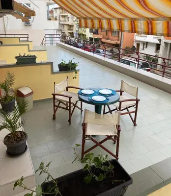 a patio with a table and chairs in a building at Sozopol Apartment 3 in Sozopol
