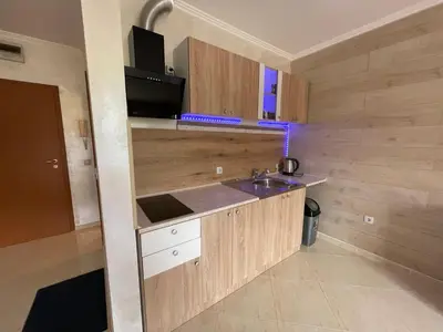 a small kitchen with a sink and a microwave at Sveti Vlas Modern Studio with Pool & Balcony by Flat Mаnаger in Sveti Vlas