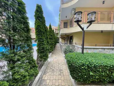 a building with trees and a sidewalk next to a building at Sveti Vlas Modern Studio with Pool & Balcony by Flat Mаnаger in Sveti Vlas