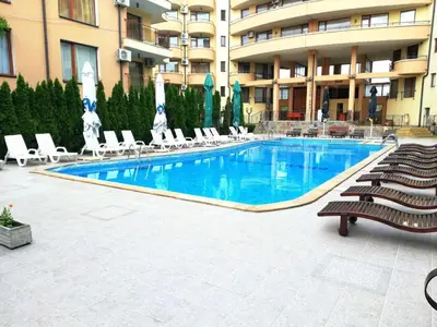 a large swimming pool with chairs and umbrellas at Sveti Vlas Modern Studio with Pool & Balcony by Flat Mаnаger in Sveti Vlas