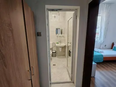 a bathroom with a shower and a sink in a room at Къща за гости Пиргос in Burgas City