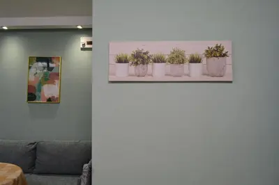 a living room with potted plants on a shelf at City Center Apartment in Burgas City