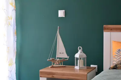 a toy sailboat on a table in a bedroom at City Center Apartment in Burgas City