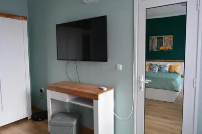 a room with a tv and a table with a television at City Center Apartment in Burgas City