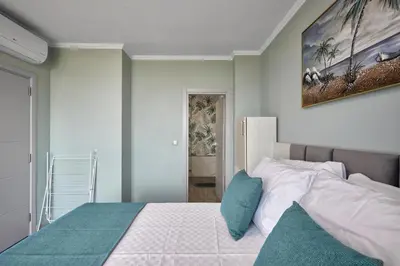 a bedroom with a bed and a painting on the wall at 3BD Beach Paradise with a Stunning View with Parking by Flat Mаnаger in Nesebar