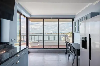 a kitchen with a table and chairs and a large window at 3BD Beach Paradise with a Stunning View with Parking by Flat Mаnаger in Nesebar