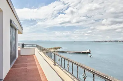 a balcony of a house with a view of the water at 3BD Beach Paradise with a Stunning View with Parking by Flat Mаnаger in Nesebar