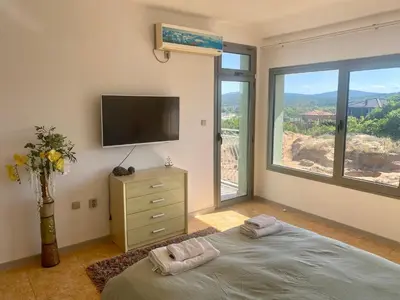 a bedroom with a flat screen tv and a bed at Gorgeous, 1 Bed Apt, Sea Views. in Duni