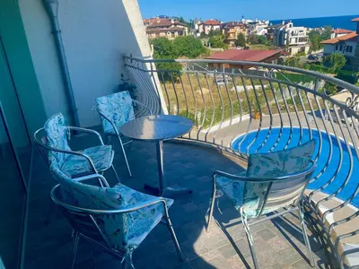 a balcony with chairs and a table and a table and chairs at Gorgeous, 1 Bed Apt, Sea Views. in Duni