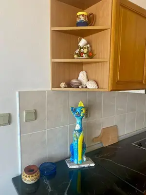 a toy cat sitting on top of a kitchen counter at Gorgeous, 1 Bed Apt, Sea Views. in Duni