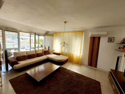a living room with a couch and a table at Comfort Flat in Burgas City