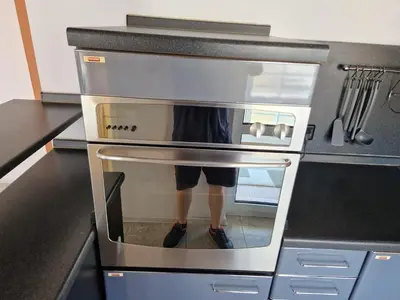 a person is standing inside of an oven at Comfort Flat in Burgas City