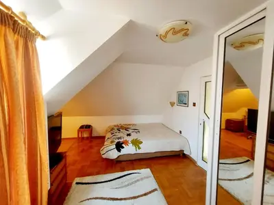a bedroom with a bed in a attic at Comfort Flat in Burgas City