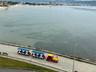 a small train is parked next to the water at Sea View Private Studio Paradiso B 509 in Nesebar