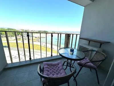 a balcony with a table and chairs and a view of the ocean at Sea View Private Studio Paradiso B 509 in Nesebar