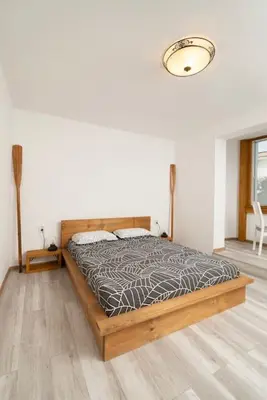 a bedroom with a bed with a wooden frame at Boutique Blue Apartment in Sveti Vlas