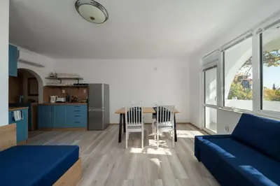 a living room with a blue couch and a table at Boutique Blue Apartment in Sveti Vlas