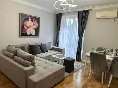 a living room with a couch and a table at MARINA Apartments in Ravda