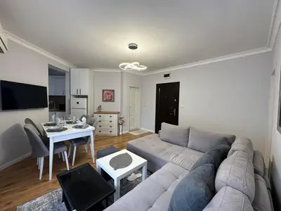 a living room with a couch and a table at MARINA Apartments in Ravda