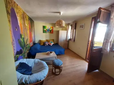 a bedroom with a blue bed and a table at Surf house in Burgas City