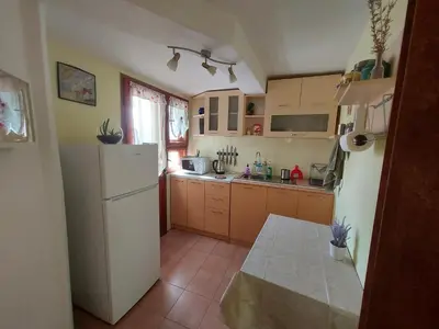 a kitchen with a white refrigerator and a window at Surf house in Burgas City