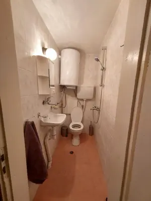 a small bathroom with a toilet and a sink at Surf house in Burgas City