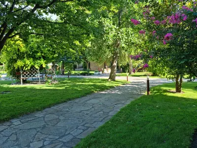 a walkway in a park with trees and grass at Garden of Eden - Apartament Niya in Sveti Vlas