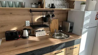a kitchen with a sink and a white refrigerator at Apartment ADELINA in Tsarevo
