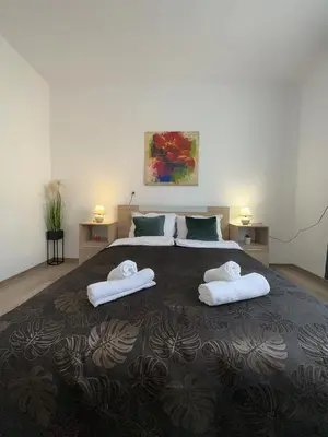 a bedroom with a large bed with towels on it at Apartment ADELINA in Tsarevo