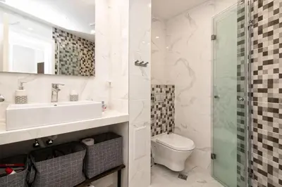 a bathroom with a sink and a toilet and a shower at Greek quarter flat two BR next to Sea Garden in Varna City