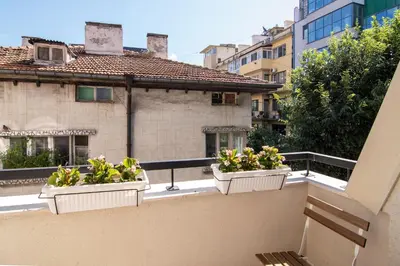 a balcony with three plants in white containers on it at Greek quarter flat two BR next to Sea Garden in Varna City