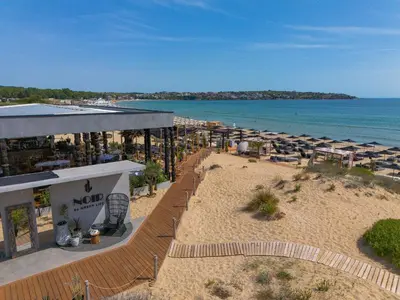 an aerial view of a beach with umbrellas and the ocean at Green Line Apartament Sozopol in Sozopol