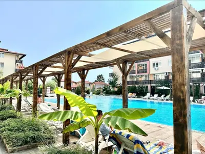 a pool at a resort with chairs and a canopy at Chateau Aheloy 2 - Menada Apartments in Aheloy
