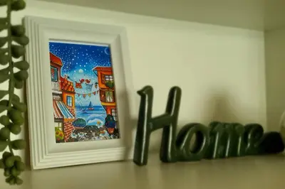 a sign that says home next to a picture at Ika apartment in Burgas City