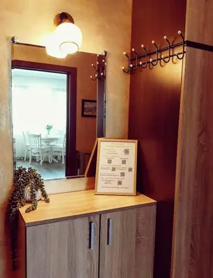 a mirror and a counter with a sign in a room at Ika apartment in Burgas City