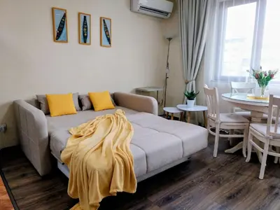 a living room with a couch and a table at Ika apartment in Burgas City