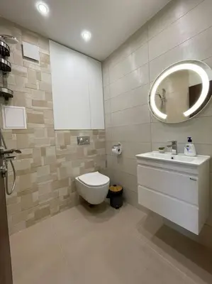 a bathroom with a toilet and a sink and a mirror at Studio Green Зелено Студио in Burgas City