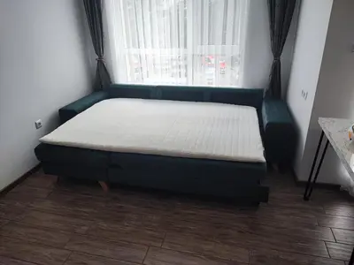 a bed in a room with a large window at Studio Green Зелено Студио in Burgas City