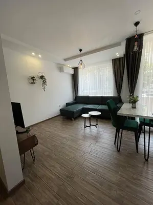 a living room with a couch and a table at Studio Green Зелено Студио in Burgas City