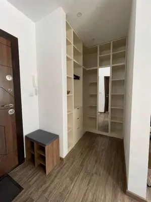 a walk in closet with a bench in a room at Studio Green Зелено Студио in Burgas City