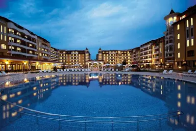 a large swimming pool in a city at night at Royal Sun Complex in Sunny Beach
