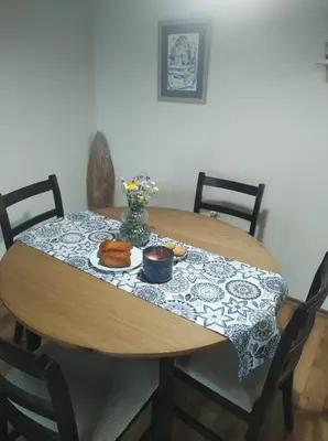 a wooden table with a plate of food on it at Апартамент в Oasis beach Kamchia - Стъпки в пясъка in Kamchia