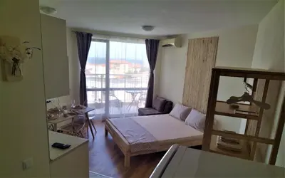 a small room with a bed and a balcony at Elisa Studio in Byala