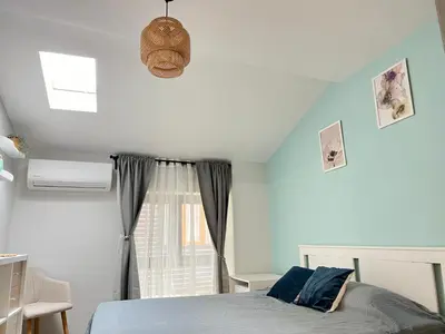 a bedroom with a bed and a window at Мореплавателите / The seafarers in Sozopol