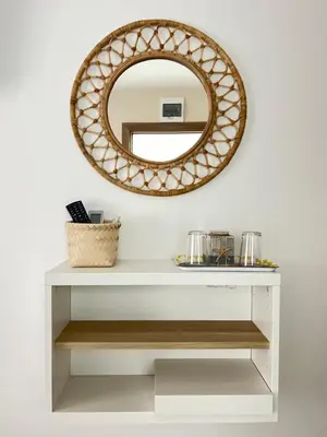 a mirror above a white console table with a shelf at Мореплавателите / The seafarers in Sozopol