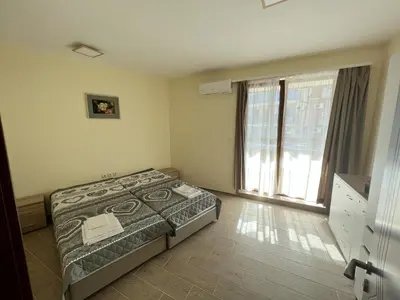 a bedroom with a bed and a large window at Sea View 2BR Apartment Sozopol in Sozopol
